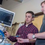 Flexible tool to boost recovery A NEW SURGICAL PATH: Raynham-based Medrobotics' flexible robotic surgical device, being demonstrated by mechanical engineer Ian Darisse, left, and biomedical engineer Rich Kuenzler, allows surgeons better access to body parts. / PBN PHOTO/MICHAEL SALERNO