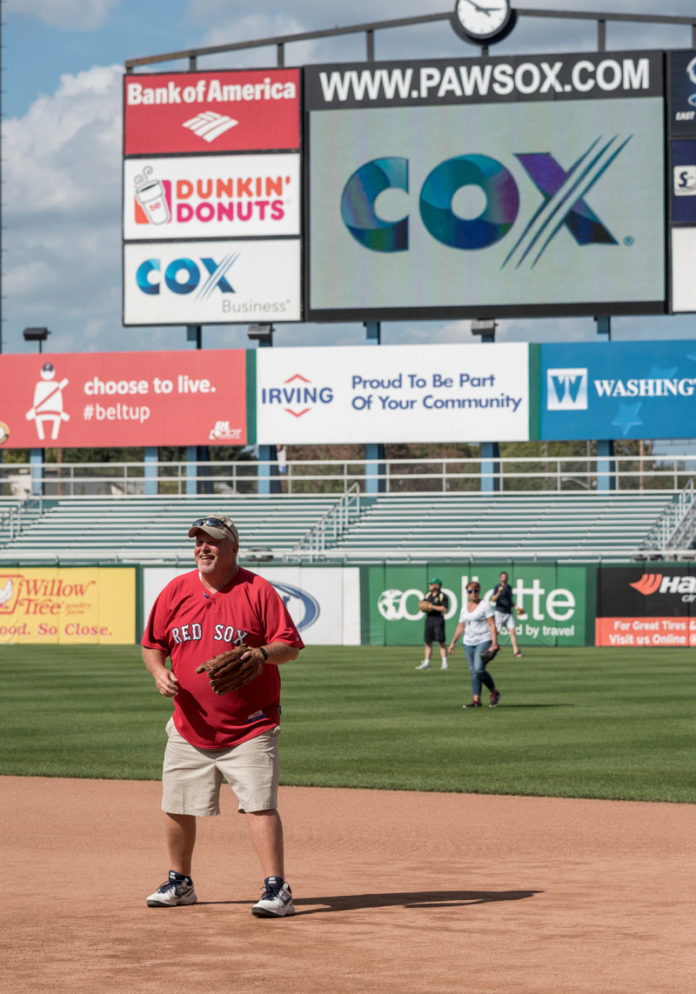 FIELD OF DREAMS: Cox Business Director of Sales Steve Hughes is ready for action in the infield during a recent company outing at McCoy Stadium in Pawtucket. / PBN PHOTO/MICHAEL SALERNO