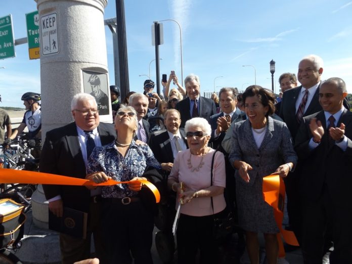 THE RIBBON CUTTING of the George Redman Linear Park & Bike Path on the Washington Bridge on Monday brought out family members of the late East Providence environmental activist, George Redman, as well as a number of public officials, including Gov. Gina M. Raimondo, front row, second from right, and Providence Mayor Jorge O. Elorza, far right. / COURTESY R.I. DEPARTMENT OF ENVIRONMENTAL MANAGEMENT