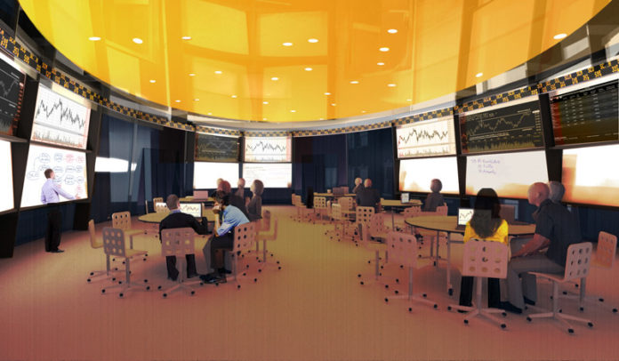 PLUGGED IN: Providence College's planned School of Business will feature a trading room, as depicted in the above rendering, that will include a Bloomberg terminal for real-time connections to the stock market. / COURTESY SYMMES MAINI  & MCKEE  ASSOCIATES