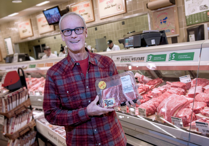 WASTE NOT: Michael Brown, CEO and president of Packaging 2.0, holds the meat-packaging tray that his company produces from 100 percent recycled materials and which itself can be recycled. / PBN PHOTO/MICHAEL SALERNO