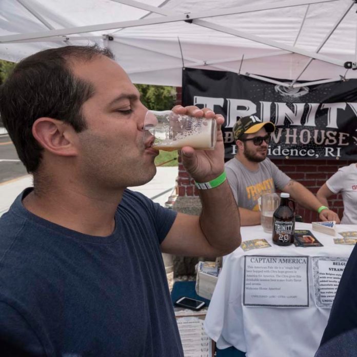 HE'LL DRINK TO THAT: Craft brewers that took part in the Ocean State Beer Festival in Westerly attracted beer aficionados, including Bob Bigelli of Glocester, to taste the growing number of local offerings. / PBN PHOTO/ MICHAEL SALERNO