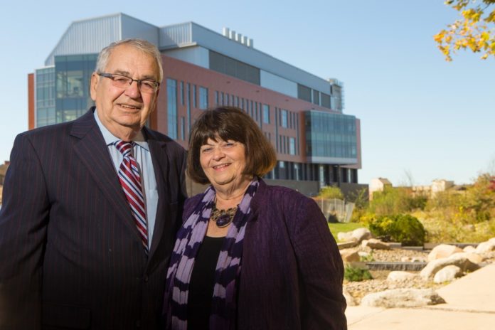 RICHARD BEAUPRE, founder and CEO of Lincoln-based ChemArt, joins Winifred Brownell, dean of the University of Rhode Island's College of Arts and Sciences, outside the newly named Richard E. Beaupre Center for Chemical and Forensic Sciences. / COURTESY UNIVERSITY OF RHODE ISLAND FOUNDATION/JOE GIBLIN