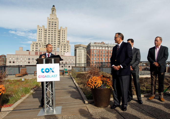 PROVIDENCE MAYOR JORGE O. Elorza is shown at the podium during Cox Communications' announcement about the launch of gigabit Internet service in Providence.  Also shown, from left to right, Jay Allbaugh, senior vice president and region manager, Cox Communications; Dan Nichols, project manager for the Foundry building; and Buff Chace, managing partner, Cornish Associates. / COURTESY COX COMMUNICATIONS