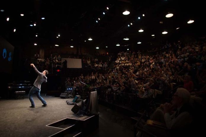 SELF-AWARE: Steven Keating, one of the Business Innovation Factory's 2015 Summit speakers, takes a selfie with the crowd during his talk in September. / PBN FILE PHOTO/STEPHANIE ALVAREZ EWENS