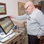 Nonprofits boost access to tools for disabled THE BIG PICTURE: Stephen Mitchell uses his video magnifier to read at his condo in Narragansett. Mitchell has macular degeneration and uses the magnifier to read his newspaper, the mail and pill bottle labels. Several nonprofits are experiencing demand for this type of technology and iPads in particular, and the nonprofits that work with the Rhode Island Assistive Technology Access Partnership have experienced staffing growth and increases in demand for these devices in the past year. / PBN PHOTO/MICHAEL SALERNO