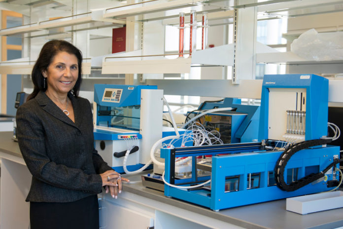 EQUIPPED TO LEAD: Paula Grammas is the incoming director of the George & Anne Ryan Institute for Neuroscience at the University of Rhode Island. Grammas is surrounded by laboratory equipment in the institute, which has offices in the College of Pharmacy on URI's South Kingstown campus. / COURTESY  NORA LEWIS