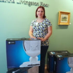 Corin Nava, co-founder of the national nonprofit Project Sweet Peas, stands recently with a donation of Mamaroo swings for infants for the Women & Infants Hospital of Rhode Island.                    / Women & Infants Hospital of Rhode Island