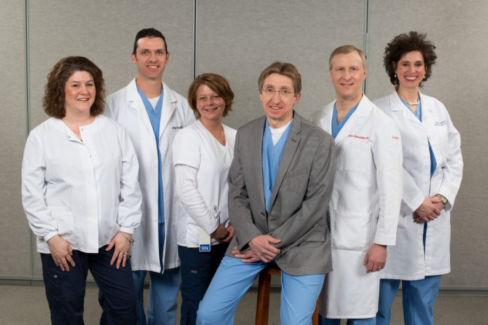 The bariatric surgery team members at Roger Williams Medical Center are, from left, Jennifer Parker, R.N., BSN, clinical nurse manager; Jeremy Frissell, P.A.-C; Jina Smith, R.N.; Dr. Dieter Pohl, director and founder; Dr. Aaron B. Bloomenthal; and Holli Brousseau, R.N., MSN, bariatric surgery coordinator. / PHOTO/PETER GOLDBERG