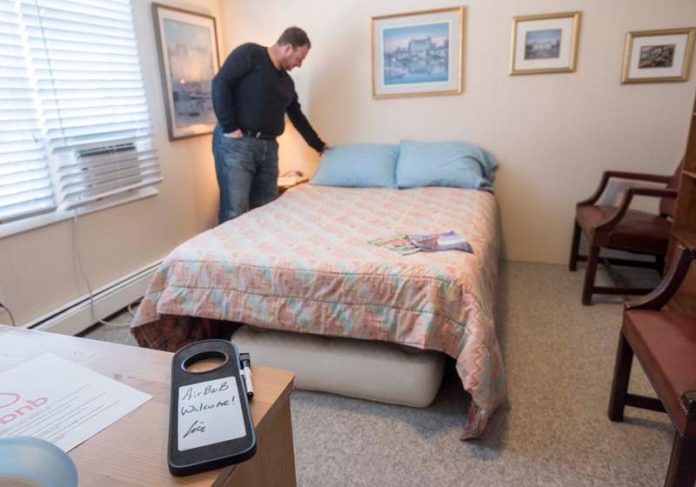 GUEST  QUARTERS: Cranston Airbnb host Eric Weiner readies one of two rooms he rents to travelers. / PBN PHOTO/ MICHAEL  SALERNO
