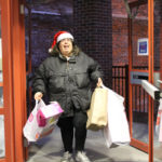 SPECIAL DELIVERY: Volunteer Julie Silva delivers bags from a truckload of toys to the 2014 Holiday Drive at Children's Friend in Providence. / COURTESY CHILDREN'S FRIEND
