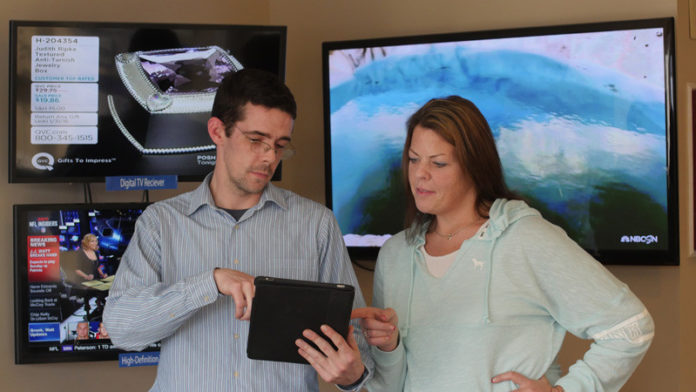 MORE THAN MAINSTREAM: Jamie Griffin, Full Channel's director of technology, shows Jodi Kopecky, a Full Channel customer from Warren, how to stream video on a tablet with Full Channel's TV Everywhere platform at the firm's office in Warren. Video streaming has contributed to a consumer demand for higher Internet speeds. / COURTESY  MATTHEW HARWOOD/FULL CHANNEL INC.