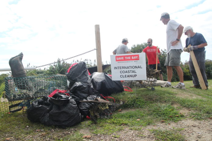 VOLUNTEERS ARE seen with the bags of trash they collected in Narragansett at Save The Bay's annual coastal cleanup in September. / COURTESY SAVE THE BAY