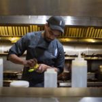 SECRET SAUCE: Antonio Wormley, Milk Money executive chef, in the kitchen of the Providence eatery. The 25-year-old Philadelphia native sees cooking as a form of self-expression. He particularly enjoys "re-creating classics into something more modern and trendy." / PBN PHOTO/RUPERT WHITELEY
