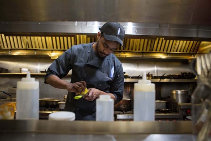SECRET SAUCE: Antonio Wormley, Milk Money executive chef, in the kitchen of the Providence eatery. The 25-year-old Philadelphia native sees cooking as a form of self-expression. He particularly enjoys 