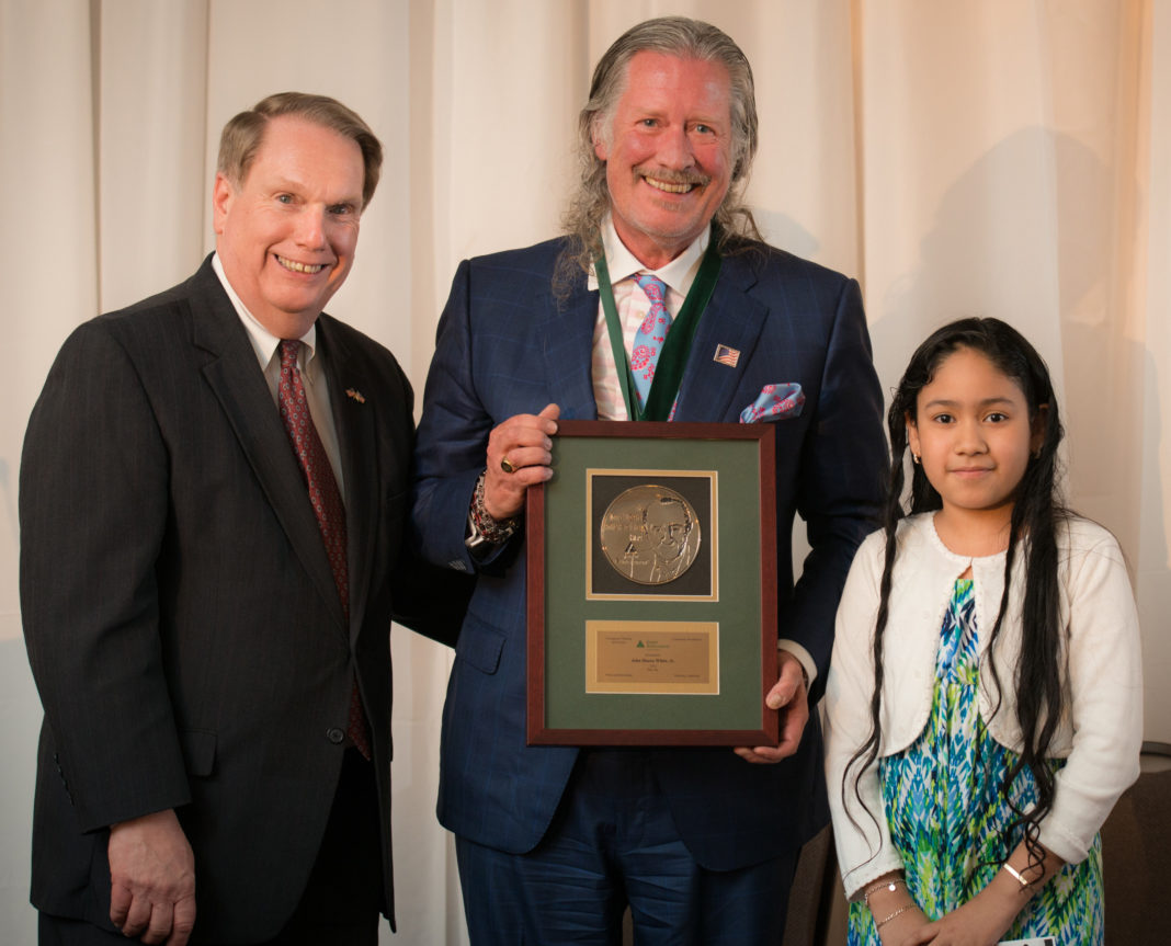 JA&rsquo;s Education Committee Chairman, Steve Kitchin of New England Tech, presents Taco Comfort Solutions CEO, John Hazen White Jr. with his 2015 award. With Mr. White is Melani Dominguez, a student from his JA class at Carl Lauro Elementary School.