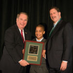 Junior Achievement Announces 2016 Profile in Excellence Award Recipients JA’s Education Committee Chairman, Steve Kitchin of New England Tech, presents President/CEO Neil Steinberg with The Rhode Island Foundation’s 2014 award. With Neil is Hamlet Suazo, a student from his JA class at Carl Lauro Elementary School.
