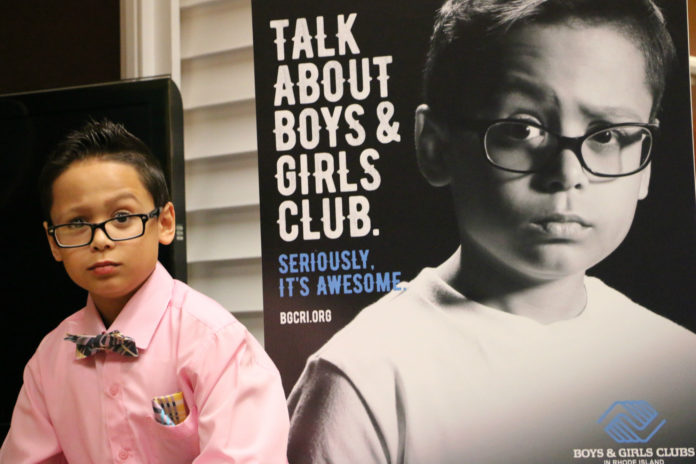 Dennis Martinez, 10, of Pawtucket, stands next to a likeness featured in a new print ad for a Rhode Island Boys & Girls Club ad campaign. / COURTESY DOUG CUDDEBACK/DUFFY & SHANLEY