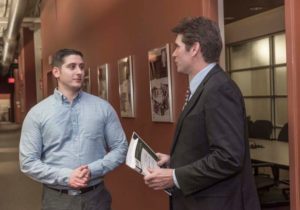 MOST FOR THE MONEY: Johnson & Wales University student David Sotnik, left, speaks with professor Roger Achille. Sotnik has chosen the school's specialized M.S. in human resources over an MBA. The M.S. program costs about $6,000 less than the MBA. / PBN PHOTO/ MICHAEL SALERNO