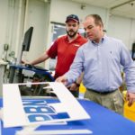 ATTENTION TO DETAIL: Nick Boruta, a tier one digital cut operator, left, and National Marker Company President Michael Black are seen at the North Smithfield company. / PBN PHOTO/RUPERT WHITELEY