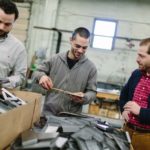 KEY PARTS OF A WHOLE: From left, account manager Taylor Kenney, production manager Jesse Godin and Custom Design Vice President Adam Dias are seen at the North Kingstown company. / PBN PHOTO/RUPERT WHITELEY