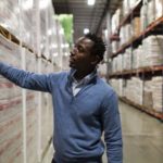 PART OF THE MISSION: Andrew Kamara, Edesia logistics/distribution manager, checks some of the nonprofit manufacturer's stock. / PBN PHOTO/RUPERT WHITELEY