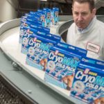 QUALITY CHECK: Al Greer, president and COO of Life Wear Technologies, examines boxes of the  CryoMAX eight-hour cold pack as they come down a line in North Kingstown. / PBN PHOTO/MICHAEL SALERNO