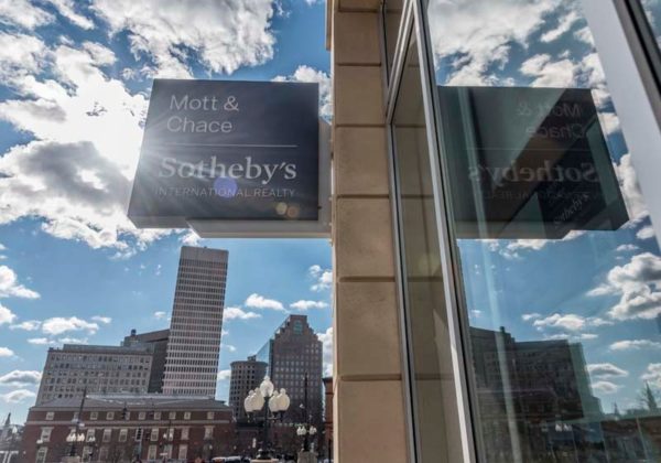 GOOD REFLECTION: A view outside the entrance to the offices of Mott &amp; Chase Sotheby's on Exchange Street. / PBN PHOTO/MICHAEL SALERNO