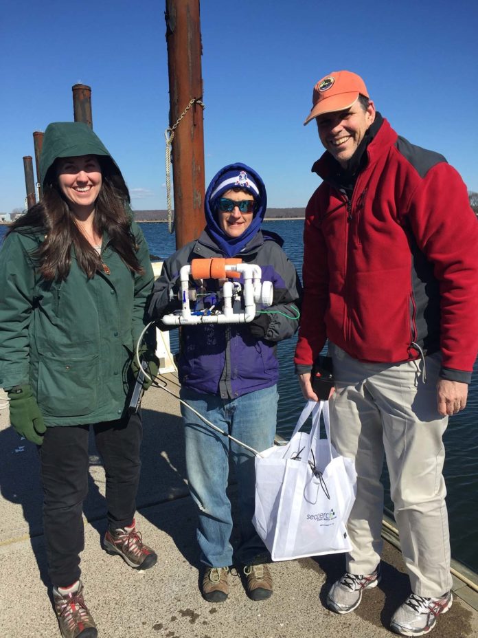 THE MARINE Technology for Teachers and Students Project Teacher Leaders Alex Romano, Cumberland High School; Shannon Donovan, Scituate High School; and William Hurley, Melrose High School, Melrose, Mass., display their newly built remotely operated vehicle during a professional development session at the University of Connecticut, Avery Point. / COURTESY URI/INNER SPACE CENTER