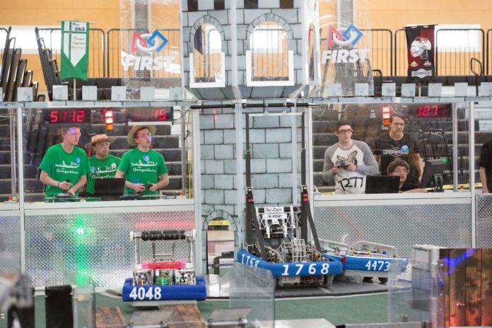 THE GONGOLIERS,  a robotics team from Ponaganset High School in the Foster Glocester school district, is seen during this past weekend’s FIRST Robotics competition in Providence. Team members are on the left. / COURTESY JOHN EDWARD CORBETT