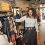 INTERNATIONAL FLAIR:  Natalie Morello, right, owner of Shoppe  Pioneer in Providence, helps Kelsey Cregg pick out clothing by a Spanish designer. / PBN PHOTO/ MICHAEL  SALERNO