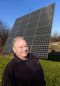 FUTURE OF ENERGY: Arnold Abatecola, a net-metering energy producer, is seen in front of the solar array at his Johnston home. / PBN PHOTO/MICHAEL SALERNO