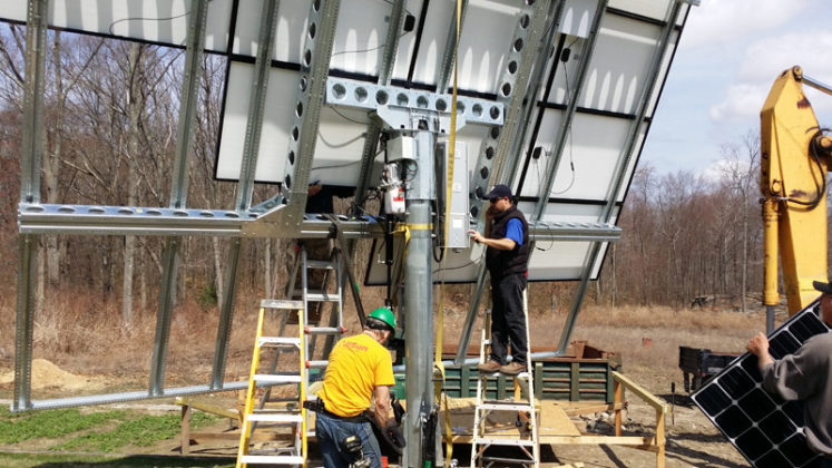 MAXIMIZING POWER: E2SOL LLC crew members work to install a dual-axis solar tracking system, which the company says outperforms static systems by 35 percent because of its ability to track the sun from sunset to sunrise. / COURTESY E2SOL LLC