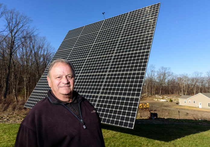 LOCAL GRID: Arnold Abatecola, a net-metering energy producer, spent $35,000 on a dual-axis tracking system three years ago. His monthly electricity bill has fallen about 75 percent. / PBN PHOTO/ MICHAEL SALERNO