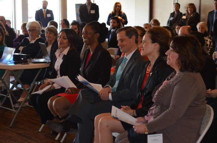 From center left to center right, Rhode Island Department of Health Director Dr. Nicole Alexander-Scott, First Gentleman Andy Moffit and Woonsocket Mayor Lisa Baldelli-Hunt listen to a Woonsocket Health Equity Zone presentation on March 31 in Woonsocket. / COURTESY RHODE ISLAND DEPARTMENT OF HEALTH