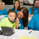 KYRIE WHITE, 4, sits on the lap of Fran Pingatore, patient and family centered care manager at Hasbro Children&rsquo;s Hospital, as he answers a call from a donor during the hospital&rsquo;s radiothon on April 7. Born with gastroschisis, resulting in short bowel syndrome, Kyrie has received extensive treatment at Hasbro Children&rsquo;s Hospital and has a positive prognosis for his future. / COURTESY HASBRO CHILDREN'S HOSPITAL