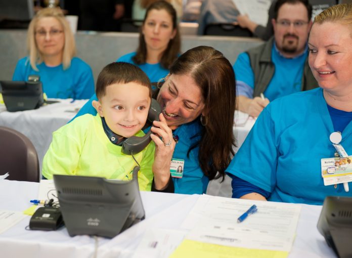 KYRIE WHITE, 4, sits on the lap of Fran Pingatore, patient and family centered care manager at Hasbro Children’s Hospital, as he answers a call from a donor during the hospital’s radiothon on April 7. Born with gastroschisis, resulting in short bowel syndrome, Kyrie has received extensive treatment at Hasbro Children’s Hospital and has a positive prognosis for his future. / COURTESY HASBRO CHILDREN'S HOSPITAL