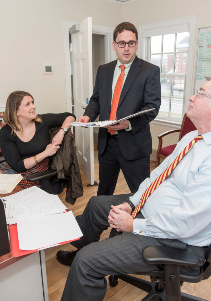 STRAIGHT FROM THE SOURCE: Zachary Sherman, HealthSource RI executive director, center, speaks with James Thorsen, deputy director of finance, and Lindsay Lang, senior legal counsel. / PBN PHOTO/MICHAEL SALERNO