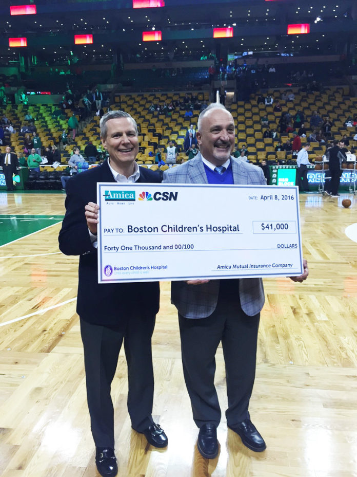 Amica Mutual Insurance Chairman, President and CEO Robert A. DiMuccio, left, presents a $41,000 check to Dick Argys, senior vice president and chief administrative officer of Boston Children’s Hospital, prior to a Boston Celtics Game at TD Garden on April 8. / COURTESY AMICA MUTUAL INSURANCE
