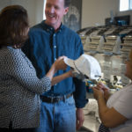 GOOD FIT: Thomas Parsons Kellogg III and his wife, Leslie, look at one of Parsons-Kellogg LLC's embroidered hats. / PBN FILE PHOTO/STEPHANIE ALVAREZ EWENS