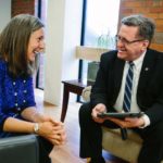 FULLY COMMITTED: John Sweeney, Providence College's CFO, meeting here with Kristine Goodwin, the vice president of student affairs, loves to solve problems for an institution at which his faith and values "tie so closely to the purpose of the institution." / PBN PHOTO/RUPERT WHITELEY