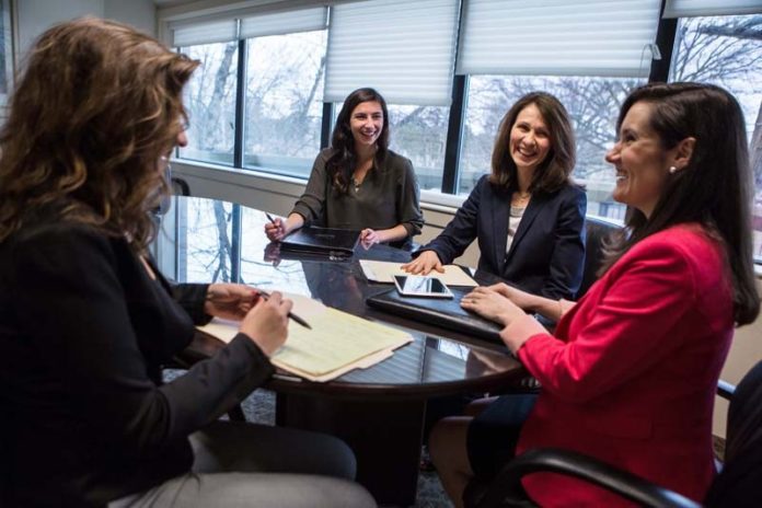 A REWARDING TEAM APPROACH: June Landry, second from right, principal and chief marketing officer for Kahn, Litwin, Renza & Co., says she learns something new every day from her team, which includes from left, Kathleen Leavenworth, Katherine Trifero and Ashley Brown. / PBN PHOTO/RUPERT WHITELEY