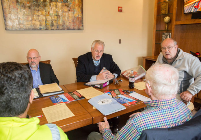 AIMING FOR REVOLUTION: Gaspee Business Network steering committee members, clockwise from left, John Niewiecki, Mike Stenhouse, Mike J. Collins, Walter McLaughlin and Tony Reposo meet at Brewed Awakenings in Warwick in April. / PBN PHOTO/TRACY JENKINS