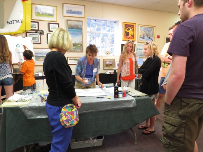 Susan Shaw, center, a member artist with Spring Bull Gallery in Newport, is seen during a Gallery Night last year. Shaw exhibits her work in porcelain, oils and watercolor at the gallery.