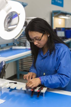 PILOT PROJECT: Manufacturing operator Evelyn Som runs a pilot assembly line for components to be used in a medical device Ximedica is developing. / PBN PHOTO/RUPERT WHITELEY