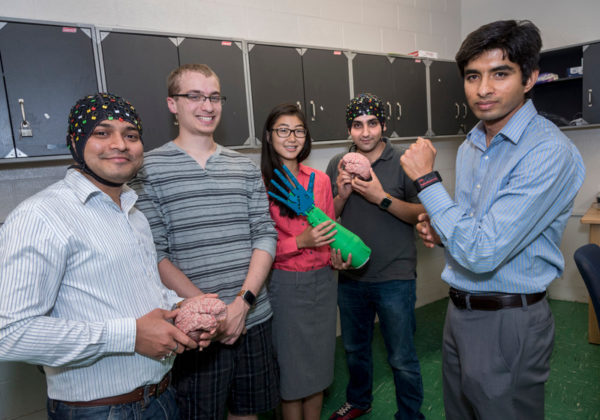 TECH COUTURE: From left, Harishchandra Dubey, a visiting scholar specializing in machine learning, Cody Goldberg, a University of Rhode Island senior majoring in biomedical engineering, URI biomedical engineering graduate students Tanya Wang and Mohammadreza Abtahi, and Kunal Mankodiya, URI associate professor of electrical, computer and biomedical engineering, are seen with devices developed as the result of a project about wearable technology in 2015. / PBN PHOTO/MICHAEL SALERNO