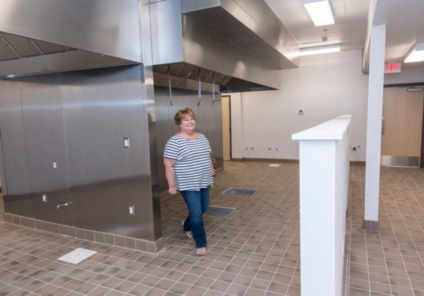 WORTH THE WAIT: Paula Rezendes, a project manager for NeighborWorks Blackstone River Valley, stands in the new kitchen incubator space, which will provide shared space for up to three entrepreneurs. (The kitchen equipment had not yet been installed.)
