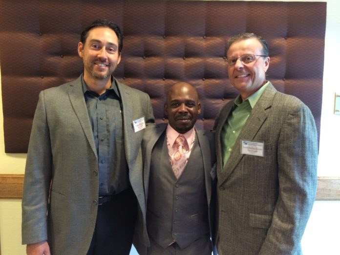 MICHAEL BAKER, Pet Food Experts Inc. owner;  Dwayne Gibson, an employee and ex-offender; and James Bettencourt, Pet Food Experts' chief operating officer, are seen at the Roadmap to Reentry Community Workforce Development Summit Wednesday. / PBN PHOTO/EMILY GOWDEY-BACKUS