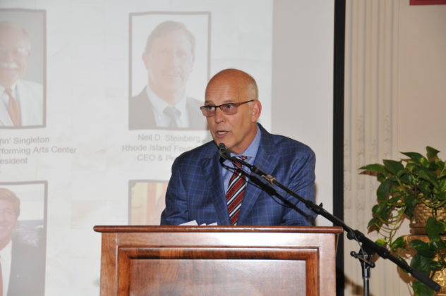 PROVIDENCE BUSINESS NEWS PUBLISHER Roger C. Bergenheim welcomes attendees to the publication's 30th anniversary gala, held at Rosecliff in Newport. Behind him are photos of some of the 30 Driving Forces selected to mark the occasion. / PBN PHOTO/MIKE SKORSKI