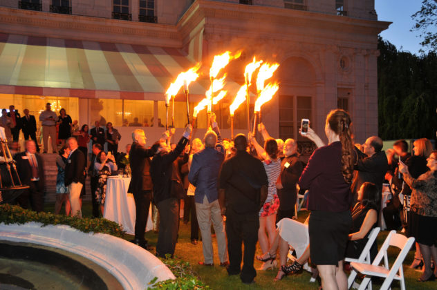 TO MARK THE OCCASION OF PBN'S 30TH ANNIVERSARY, WaterFire Executive Artistic Director Barnaby Evans led attendees in a mini-lighting of two WaterFire braziers that were placed in the fountain of Rosecliff in Newport. / PBN PHOTO/MIKE SKORSKI